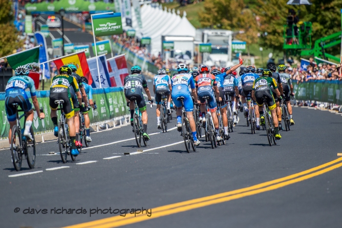 Riders approach the finish line starting the 1st of 3 final circuits on Stage 3 - Antelope Island State Park to North Salt Lake City, 2019 LHM Tour of Utah (Photo by Dave Richards, daverphoto.com)