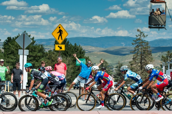The fans are excited while the gondola passengers watch from above. Stage 5 - Canyons Village Park City Mountain Resort, 2019 LHM Tour of Utah (Photo by Dave Richards, daverphoto.com)
