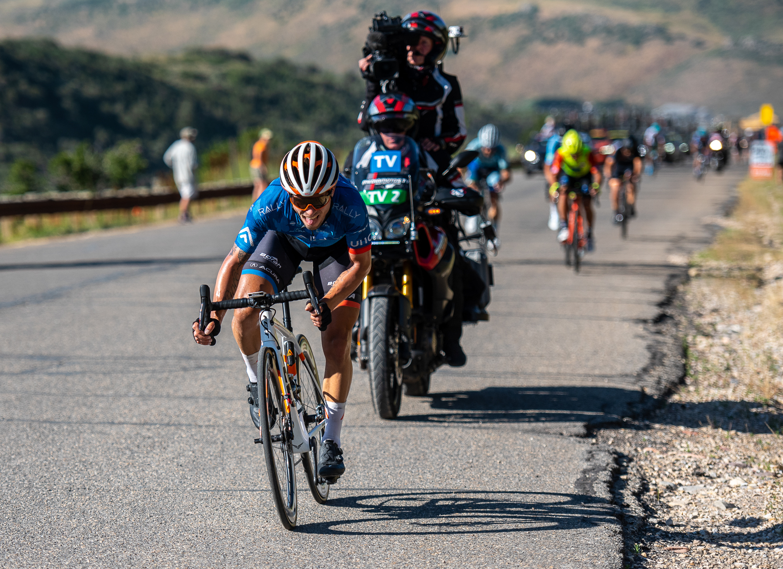 Evan Huffman (Rally UHC Cycling) drags his tongue on the ground as he crests the last KOM on the penultimate day of his career. Stage 5, 2019 Tour of Utah. Photo by Steven L. Sheffield
