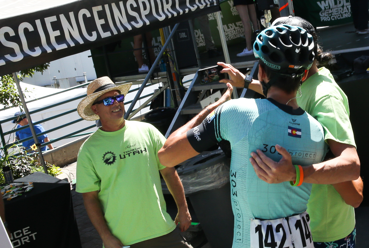 Antonio Baca takes a selfie with a volunteer at sign in. He wins America First Credit Union Fan Favorite Jersey after the final stage.