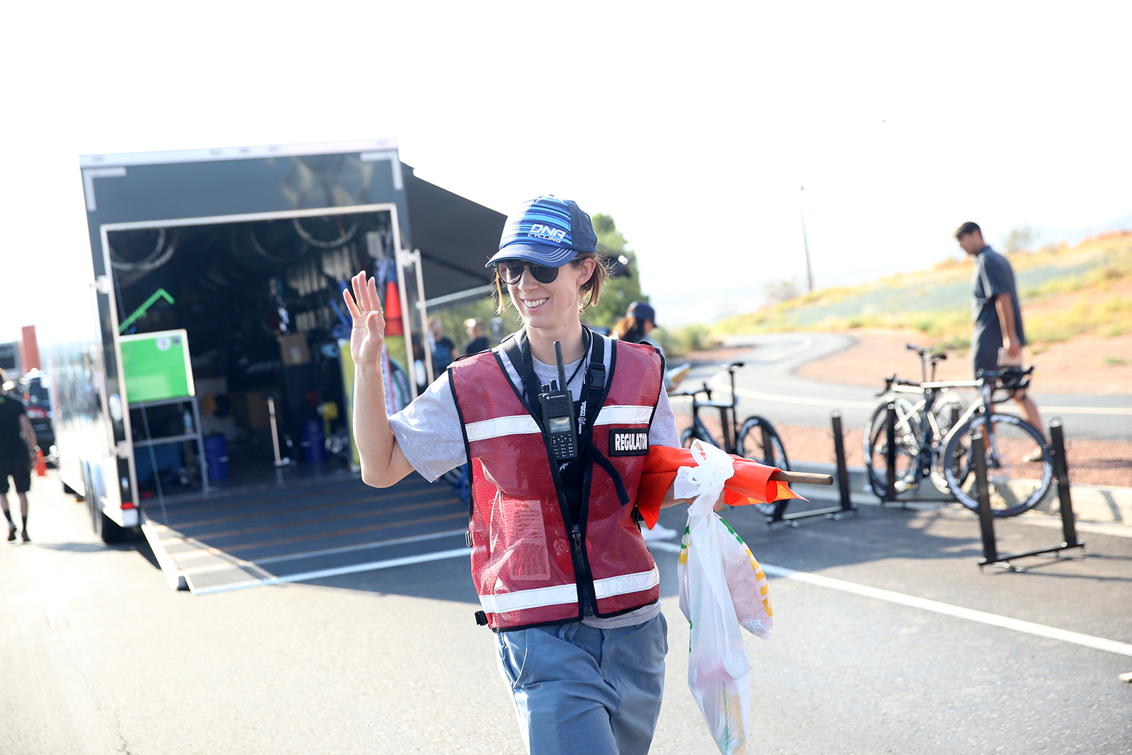 Regulator, Heather Fischer grabs lunches for the others.  2018 Tour of Utah Team Prologue, August 6, 2018, St. George, Utah. Photo by Cathy Fegan-Kim, cottonsoxphotography.net