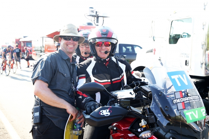 TV crew and Regulator, Tim Schaars poses for a quick photo.  2018 Tour of Utah Team Prologue, August 6, 2018, St. George, Utah. Photo by Cathy Fegan-Kim, cottonsoxphotography.net
