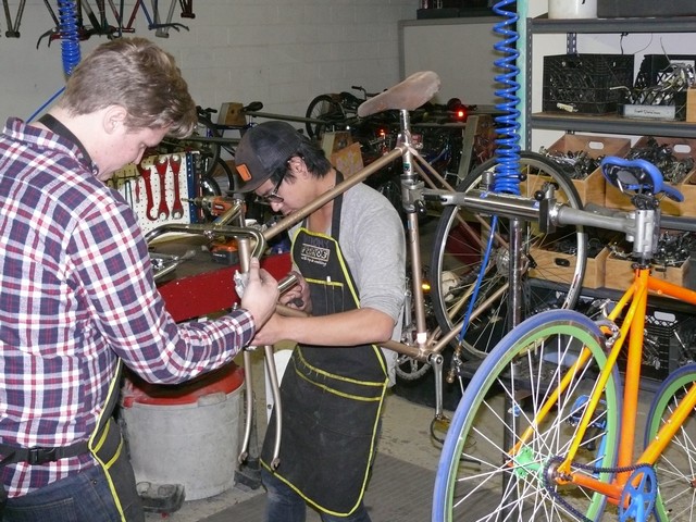 Mechanics Working On Bicycle