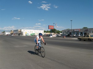 A cyclist drills it through Delta’s central business district, on Main Street.