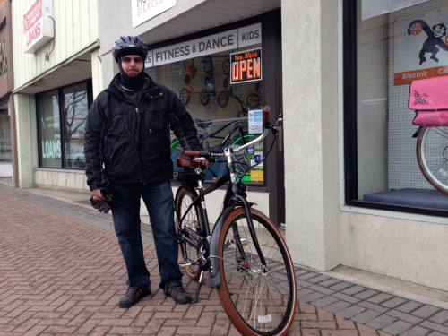 Karim Khader on a Pedego Electric Bike in fronf of Blue Monkey Bicycles in Murray. Photo: Heather Khader.