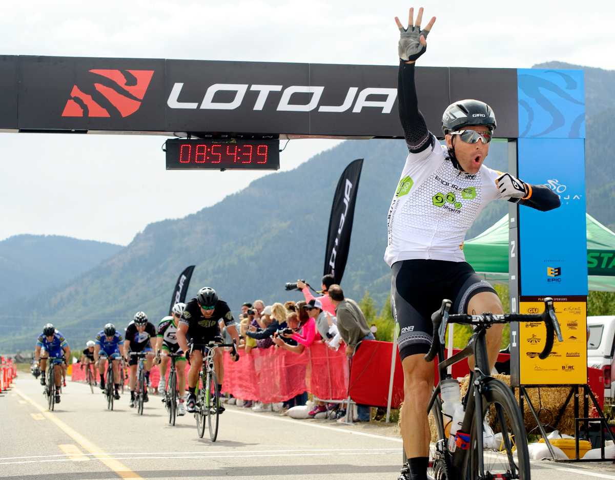Crossing the finish line in the record time of 8 hours, 45 minutes and 38 seconds, Cameron Hoffman holds up four fingers for his fourth win at LOTOJA on Saturday in Teton Village. Hoffman took his fourth Lotoja win in a sprint over Ira Sorenson and Chris Carr. The 32nd annual race from Logan, Utah to Jackson challenged cyclists through a diverse 200-mile route including three mountain passes. Photo by Price Chambers, pricechambers.photoshelter.com
