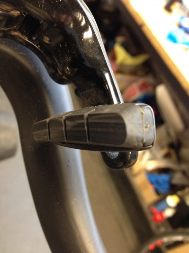 Inspect rim brake pads for wear and embedded debris.