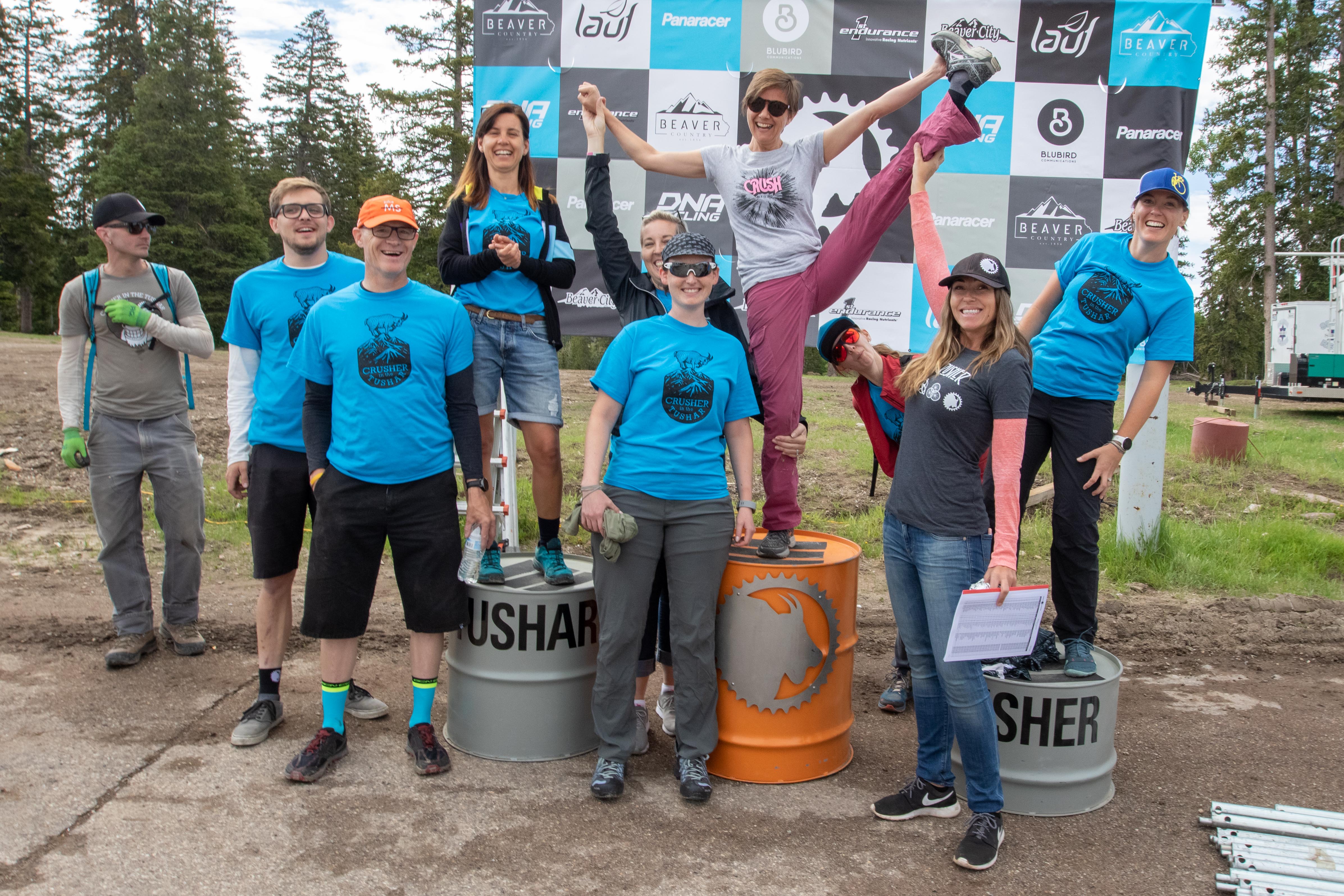 Tiffany Swindlehurst stands atop the podium with some of the many volunteers who make the Crusher a success every year. The volunteers are the true champions of this event. Photo: Angie Harker.