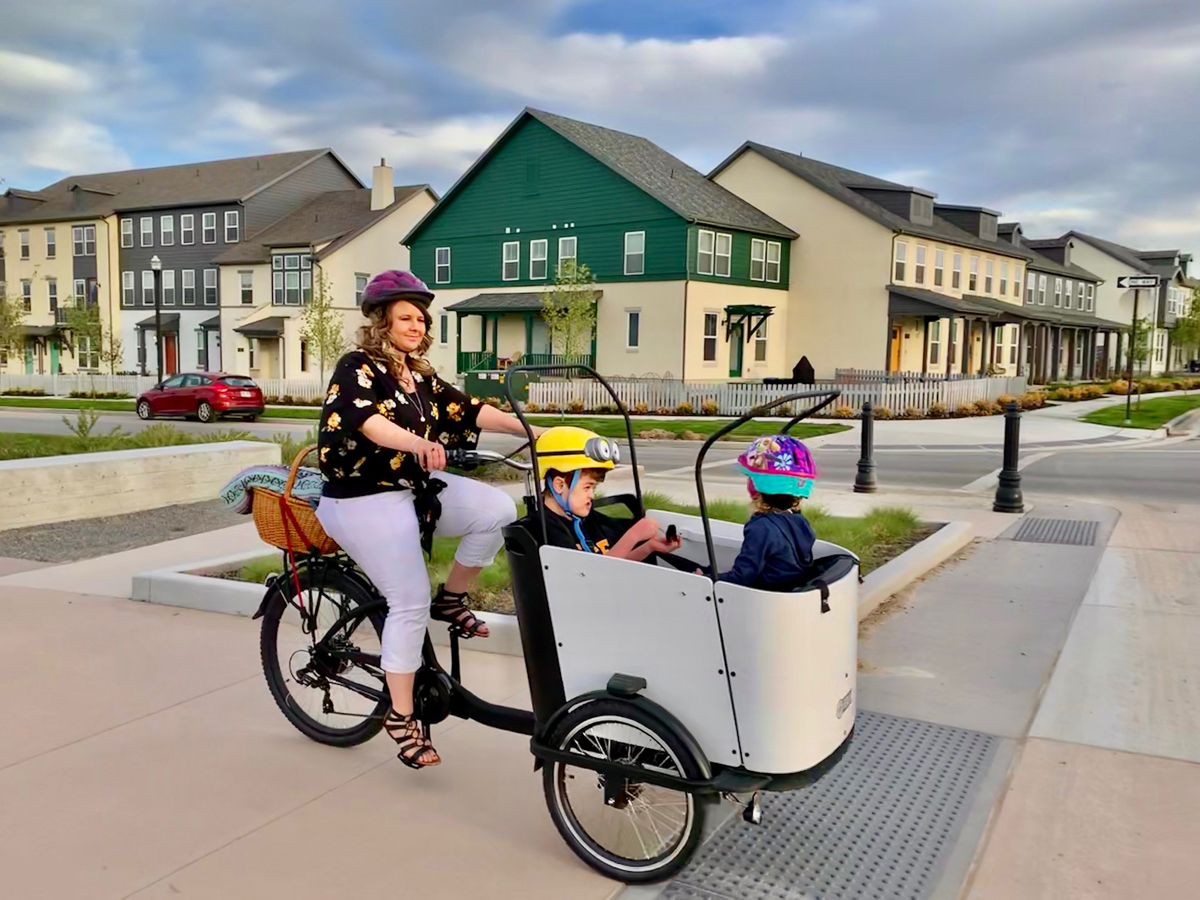 Tristin West rides through Daybreak with her kids in the cargo bike. Photo courtesy the West Family.