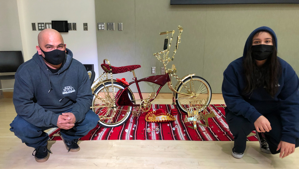 Rene and Dani Mendoza with the lowrider they built at the 2021 Salt Lake Winter Lowrider Show. Photo by Dave Iltis
